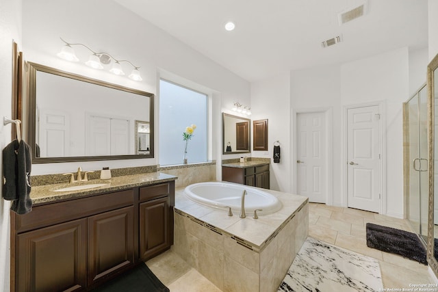 bathroom with vanity and separate shower and tub