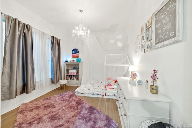 bedroom with a notable chandelier and hardwood / wood-style flooring