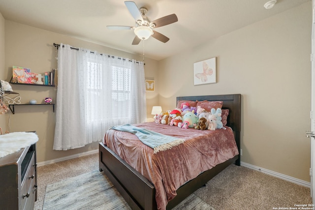 bedroom with ceiling fan and light colored carpet