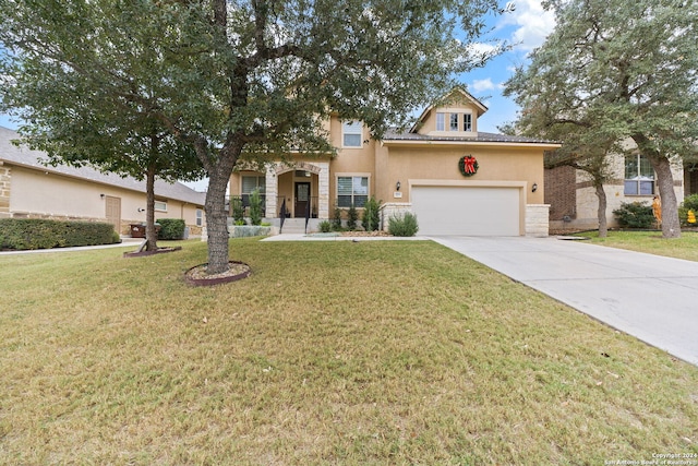 view of front of home with a front yard and a garage