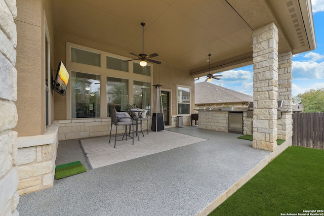 view of patio featuring area for grilling and ceiling fan