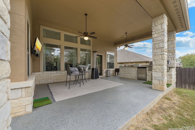 view of patio / terrace featuring ceiling fan and exterior kitchen