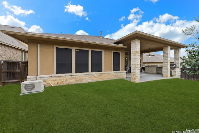 back of house featuring ac unit, ceiling fan, a yard, area for grilling, and a patio area