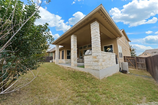 view of side of home with a lawn