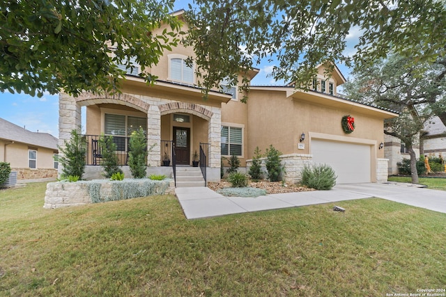 view of front of home featuring a porch, a garage, and a front lawn