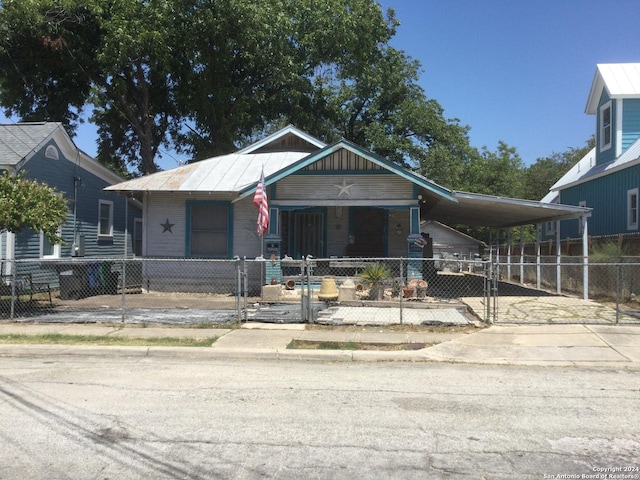 view of front of property with a porch and a carport