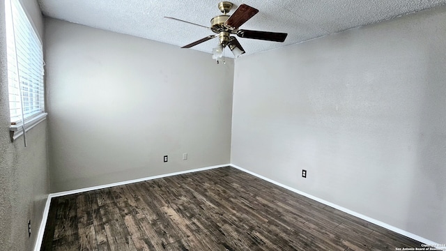 spare room with a textured ceiling, dark hardwood / wood-style floors, and ceiling fan