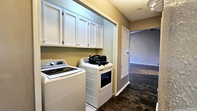 laundry room with dark hardwood / wood-style floors, cabinets, separate washer and dryer, and a textured ceiling