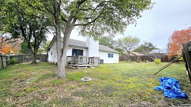 view of yard featuring central AC and a deck