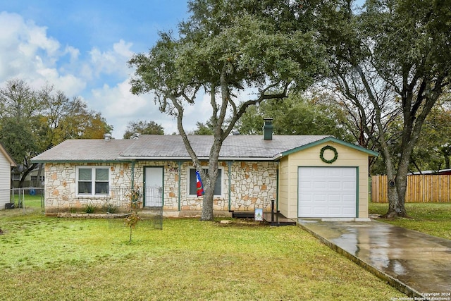 ranch-style home featuring a garage and a front yard