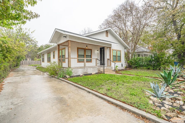 view of front of home with covered porch and a front yard