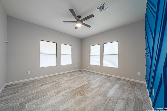 empty room featuring ceiling fan and light hardwood / wood-style floors