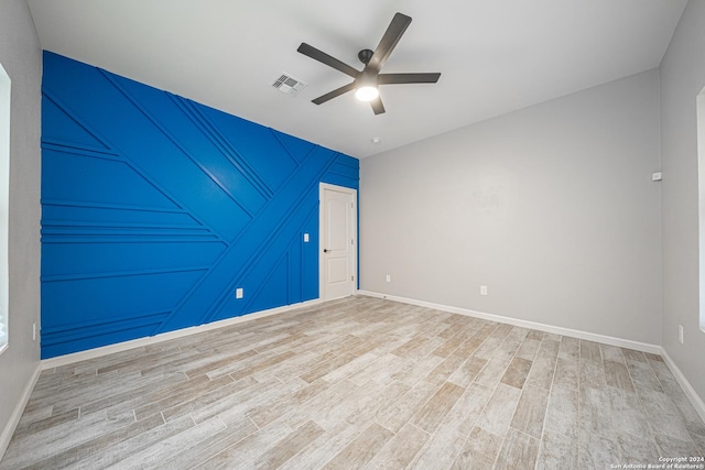 empty room featuring hardwood / wood-style floors and ceiling fan