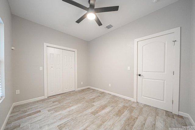 unfurnished bedroom featuring a closet, ceiling fan, and light hardwood / wood-style flooring