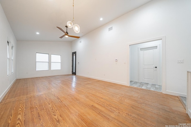 spare room with high vaulted ceiling, light hardwood / wood-style flooring, and ceiling fan