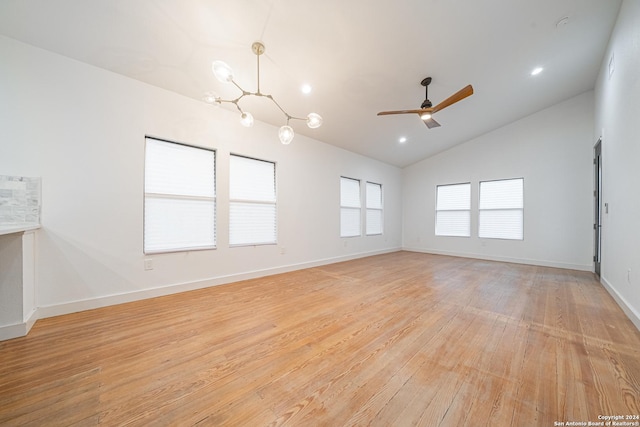 empty room featuring ceiling fan, light hardwood / wood-style flooring, and lofted ceiling