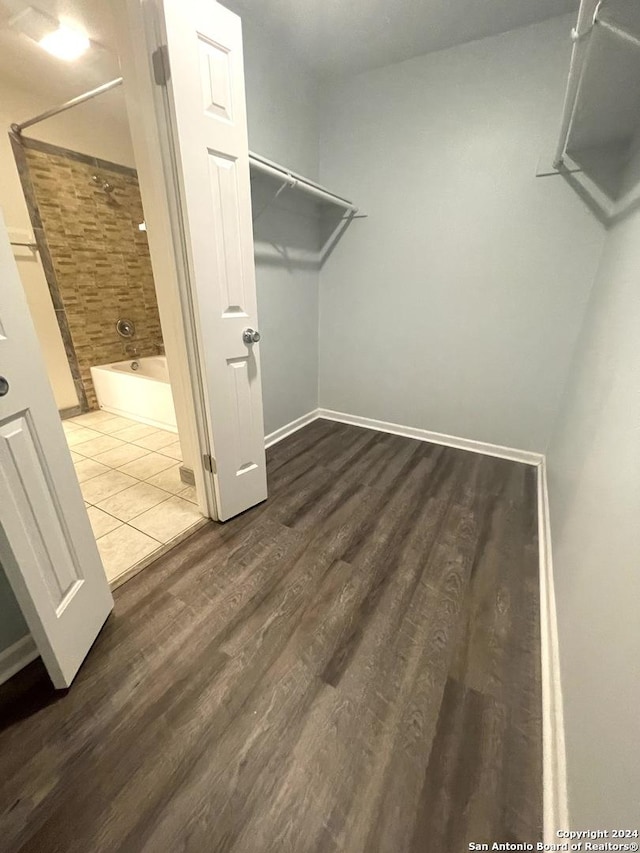 spacious closet with hardwood / wood-style flooring