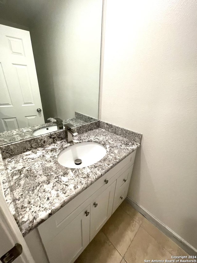 bathroom featuring tile patterned flooring and vanity