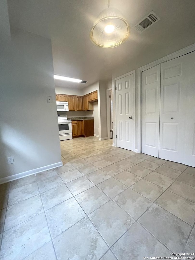 kitchen featuring white appliances and light tile patterned floors