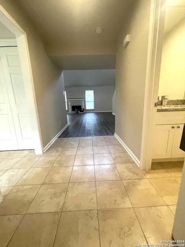 corridor featuring light wood-type flooring and sink