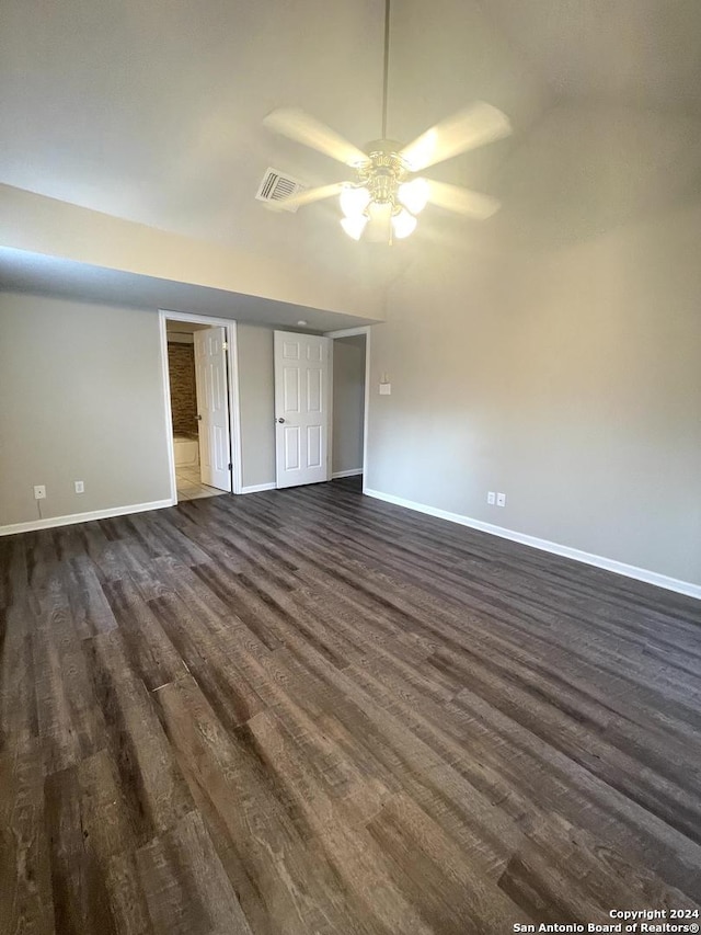 interior space with ceiling fan, dark wood-type flooring, and vaulted ceiling