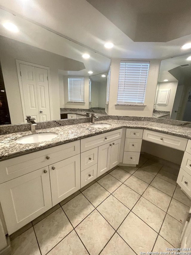 bathroom with tile patterned flooring and vanity