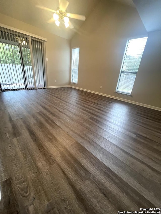 empty room featuring ceiling fan, high vaulted ceiling, and dark hardwood / wood-style floors