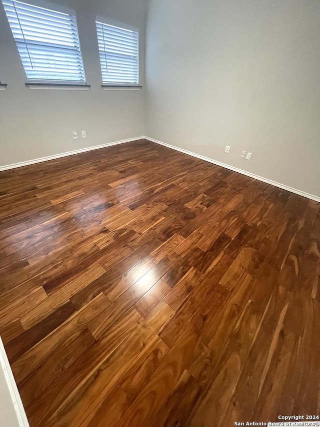 spare room with dark hardwood / wood-style flooring