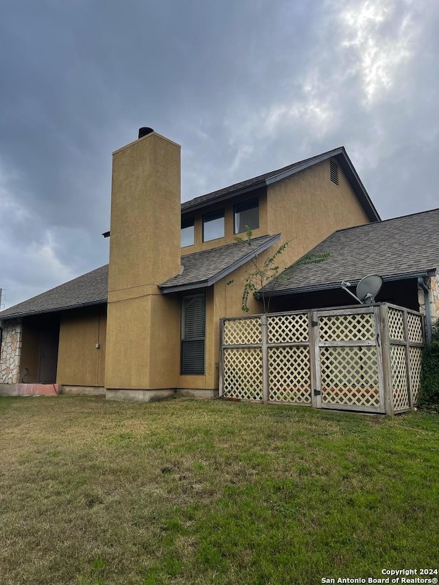 rear view of house with a lawn