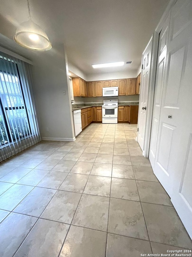 kitchen featuring light tile patterned floors and white appliances