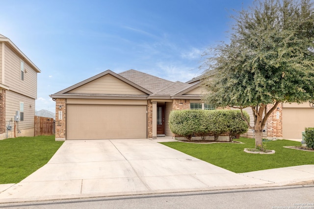 view of front of property featuring a front yard and a garage