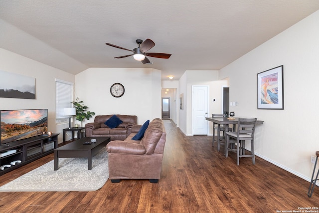 living room with dark hardwood / wood-style floors, ceiling fan, and a textured ceiling