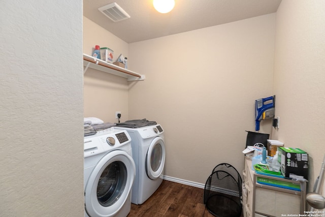 laundry room featuring washer and clothes dryer and dark hardwood / wood-style floors