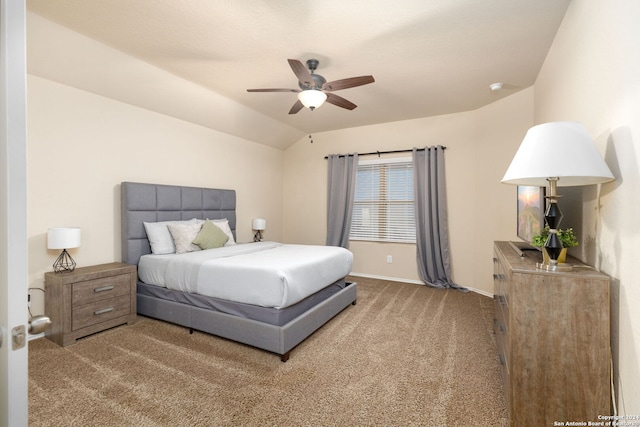 bedroom with ceiling fan, carpet floors, and lofted ceiling