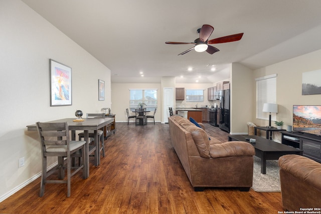 living room featuring dark hardwood / wood-style flooring and ceiling fan