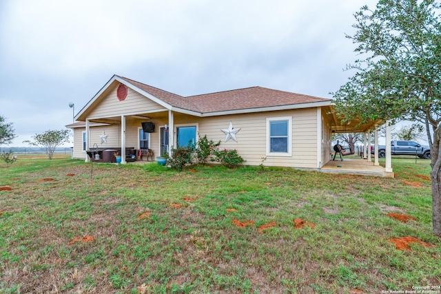 exterior space featuring a front yard and a carport