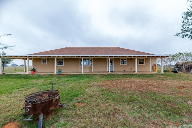 rear view of house with a yard