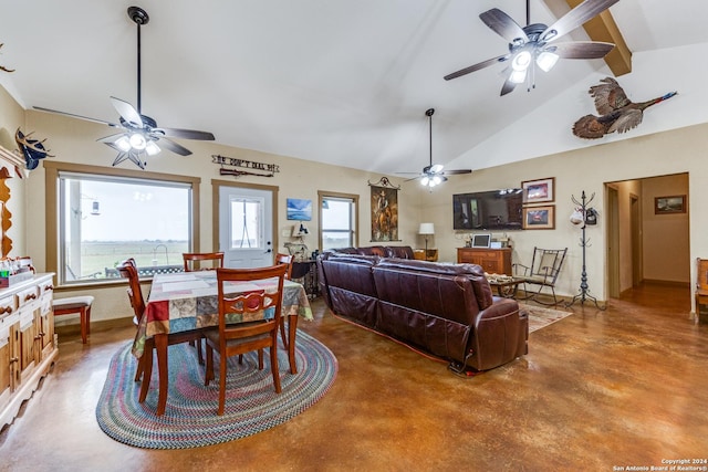 dining space with high vaulted ceiling and concrete floors