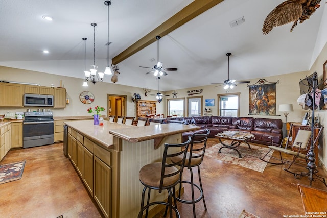 kitchen with pendant lighting, vaulted ceiling with beams, appliances with stainless steel finishes, a kitchen island, and a breakfast bar area