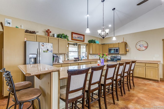 kitchen featuring sink, a center island, a chandelier, lofted ceiling, and appliances with stainless steel finishes