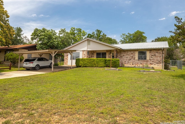 single story home featuring a front lawn and a carport