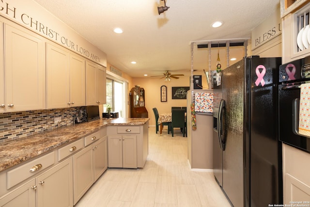 kitchen with stone counters, black appliances, ceiling fan, tasteful backsplash, and kitchen peninsula