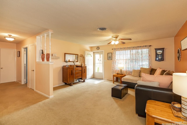 carpeted living room featuring a textured ceiling and ceiling fan