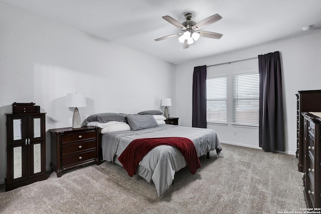 bedroom featuring light colored carpet and ceiling fan