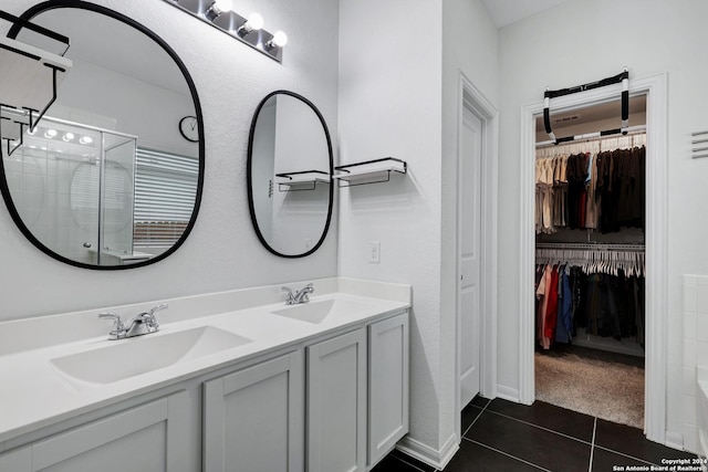 bathroom featuring tile patterned flooring, vanity, and walk in shower