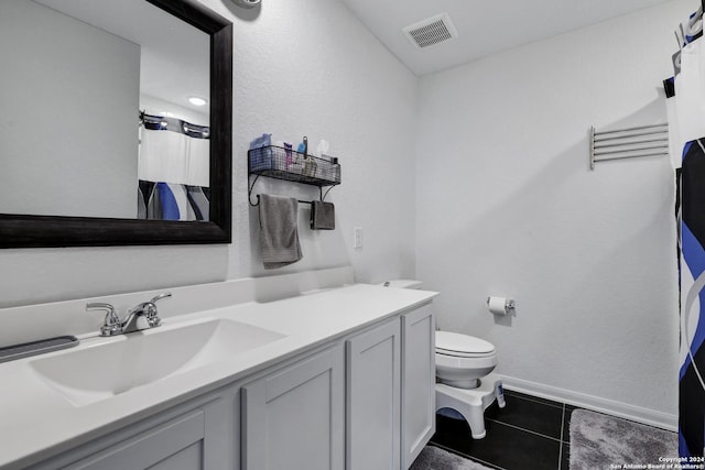 bathroom featuring tile patterned flooring, vanity, toilet, and a shower with shower curtain