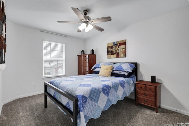 bedroom featuring dark colored carpet and ceiling fan