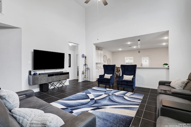 tiled living room with a high ceiling and ceiling fan