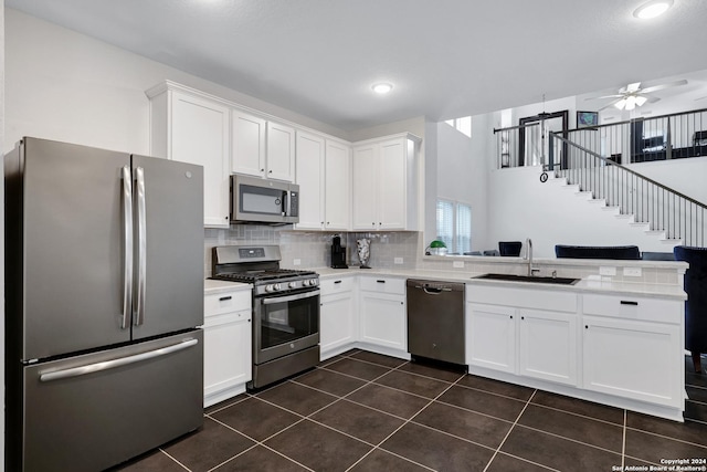 kitchen featuring appliances with stainless steel finishes, white cabinetry, ceiling fan, and sink