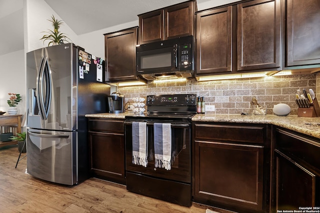 kitchen with black appliances, light stone countertops, light wood-type flooring, tasteful backsplash, and dark brown cabinetry